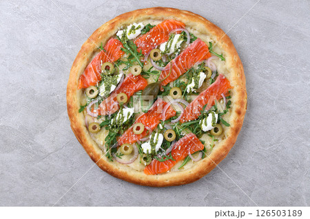 Salmon Arugula Pizza with Olives Pesto and Capers 126503189