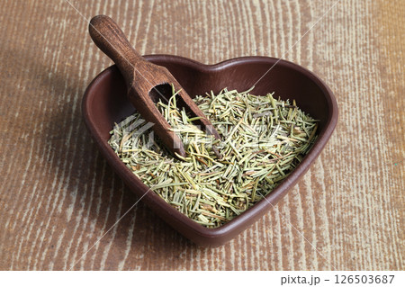 Dry organic background or texture of rosemary leaves. Healthy food concept . a wooden spoon with rosemary Dry organic background or texture of rosemary leaves. Healthy food concept . a wooden spoon with rosemary 126503687