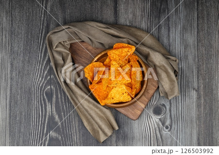 Nachos in a wooden bowl. Tortilla chips on wooden background. 126503992