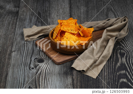 Nachos in a wooden bowl. Tortilla chips on wooden background. 126503993