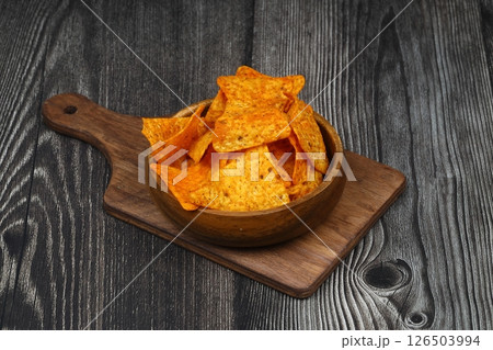 Nachos in a wooden bowl. Tortilla chips on wooden background. 126503994