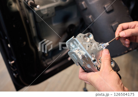 Hands Engaged in the Process of Performing Automotive Interior Repairs Effectively 126504175