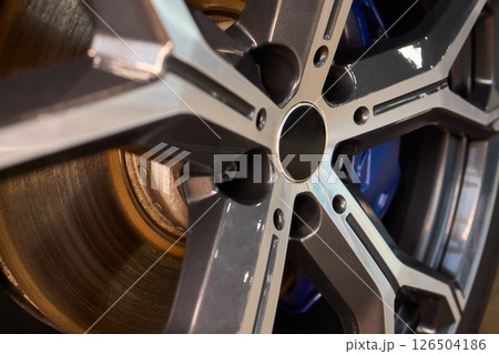 An Up Close View of a Stylish and Contemporary Car Wheel Featuring a Sporty Caliper An Up Close View of a Stylish and Contemporary Car Wheel Featuring a Sporty Caliper 126504186