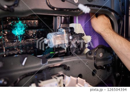 Hands Engaged in the Process of Performing Automotive Interior Repairs Effectively Hands Engaged in the Process of Performing Automotive Interior Repairs Effectively 126504394