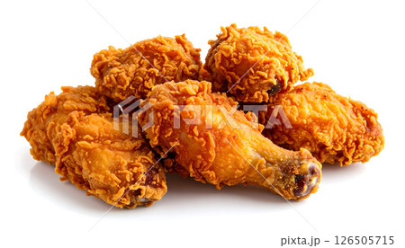 A pile of crispy, golden fried chicken pieces on a white background, a classic comfort food. 126505715