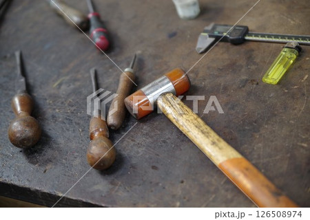 Table with a hammer and a few other tools on it 126508974