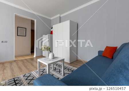 Modern Living Room with Blue Sofa and Cabinet 126510457