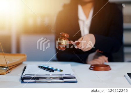 Judge gavel with Justice lawyers having team meeting at law firm background. Concepts of Law and Legal services. 126512246