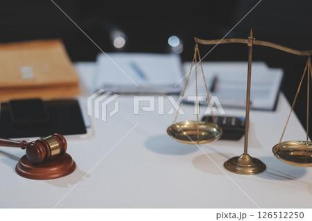 Judge gavel with Justice lawyers having team meeting at law firm background. Concepts of Law and Legal services. 126512250