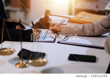 Judge gavel with Justice lawyers having team meeting at law firm background. Concepts of Law and Legal services. Judge gavel with Justice lawyers having team meeting at law firm background. Concepts of Law and Legal services. 126512259