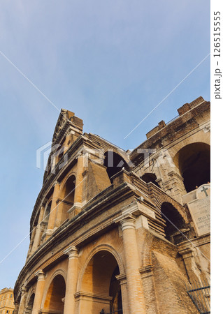 Panoramic view of old Colosseum in Rome. Beautiful popular of ancient landmark. Famous card of city of Rome, Italy. Vertical photo Panoramic view of old Colosseum in Rome. Beautiful popular of ancient landmark. Famous card of city of Rome, Italy. Vertical photo 126515555