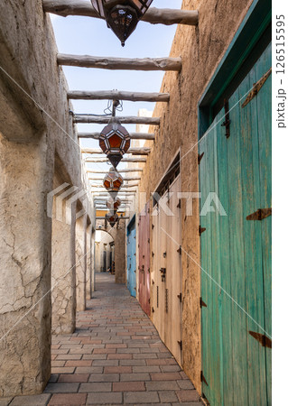 Old town in Al Seef Cultural Historical District on shores of Dubai Creek. Tourist place with old streets, houses and shops, Dubai, UAE. Vertical photo Old town in Al Seef Cultural Historical District on shores of Dubai Creek. Tourist place with old streets, houses and shops, Dubai, UAE. Vertical photo 126515595