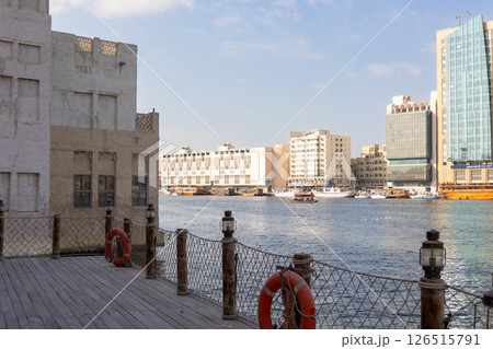 Old town in Al Seef Cultural Historical District. Beautiful view of water, old houses and new ones of Dubai Creek, Dubai, UAE. Taken off hand. High quality photo Old town in Al Seef Cultural Historical District. Beautiful view of water, old houses and new ones of Dubai Creek, Dubai, UAE. Taken off hand. High quality photo 126515791