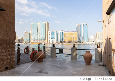 Old town in Al Seef Cultural Historical District. Beautiful view of water, old houses and new ones of Dubai Creek, Dubai, UAE. Taken off hand. High quality photo Old town in Al Seef Cultural Historical District. Beautiful view of water, old houses and new ones of Dubai Creek, Dubai, UAE. Taken off hand. High quality photo 126515828