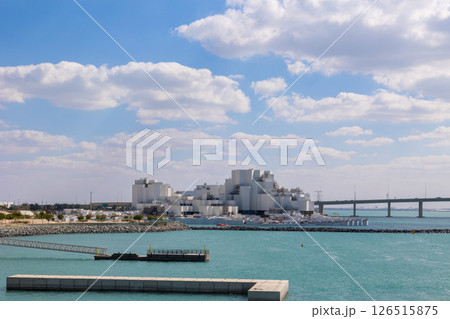 View of city with towers and skyscrapers from Saadiyat Island in Abu Dhabi, United Arab Emirates. View from water surface. High quality photo View of city with towers and skyscrapers from Saadiyat Island in Abu Dhabi, United Arab Emirates. View from water surface. High quality photo 126515875