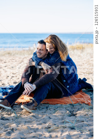Portrait happy beautiful couple in love enjoying autumn picnic in autumn park. Vertical photo. High quality photo Portrait happy beautiful couple in love enjoying autumn picnic in autumn park. Vertical photo. High quality photo 126515931