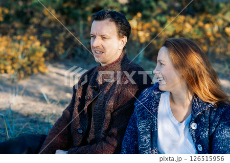 Portrait happy beautiful couple in love enjoying autumn picnic in autumn park. High quality photo 126515956