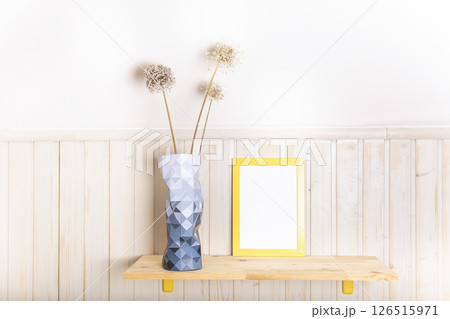 Mock up poster frame on wooden shelf with vase of flowers in Scandinavian style interior with wooden furnitures. Minimalist interior design Mock up poster frame on wooden shelf with vase of flowers in Scandinavian style interior with wooden furnitures. Minimalist interior design 126515971