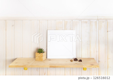 Mock up poster frame on wooden shelf with with succulent in Scandinavian style interior with wooden furnitures. Minimalist interior design Mock up poster frame on wooden shelf with with succulent in Scandinavian style interior with wooden furnitures. Minimalist interior design 126516012