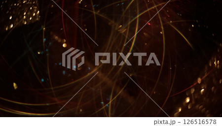 Blur garland swirling. Sparkling gold flashes. Glowing particles lens flare with glow on bokeh light abstract background. Blur garland swirling. Sparkling gold flashes. Glowing particles lens flare with glow on bokeh light abstract background. 126516578