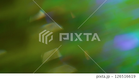 Defocused light swirls. Flare circle. Abstract green purple color lens floating glow on blurred green luminous art background. 126516619