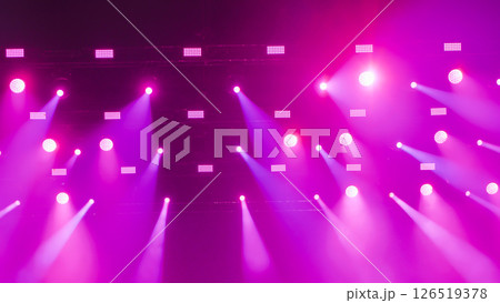 Purple stage lights illuminating the darkness creating a vibrant spectacle 126519378