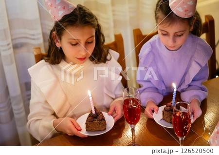 Celebrating a joyful birthday gathering with laughter, sweet treats, and sparkling beverages in a cozy indoor setting during an evening get together 126520500