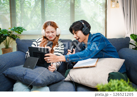 Online podcast planning with young man and woman using tablet and microphones Online podcast planning with young man and woman using tablet and microphones 126521205