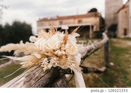 Elegant Wedding Bouquet on Rustic Wooden Fence 126521353