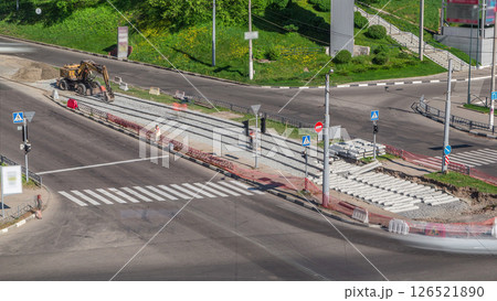 Repair works on the street aerial timelapse. Laying of new tram rails on a city street. 126521890