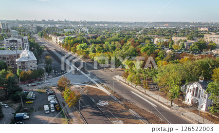 Construction site of avenue with asphalt paver, roller and truck aerial timelapse. 126522003
