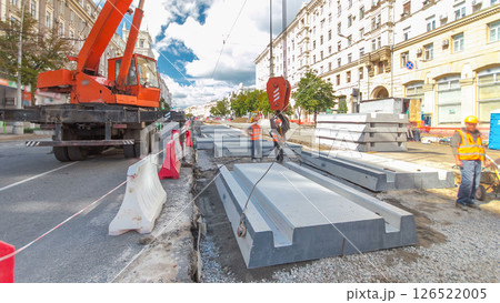 Installing concrete plates by crane at road construction site timelapse hyperlapse. 126522005