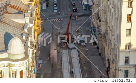 Installing concrete plates by crane at road construction site timelapse. Installing concrete plates by crane at road construction site timelapse. 126522026