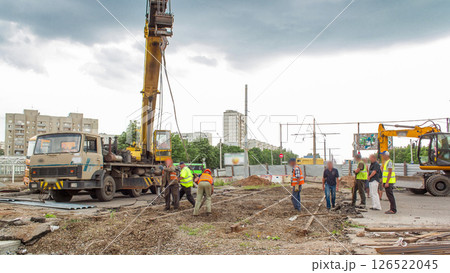Demolition of old tram rails by crane at road construction site timelapse. 126522045