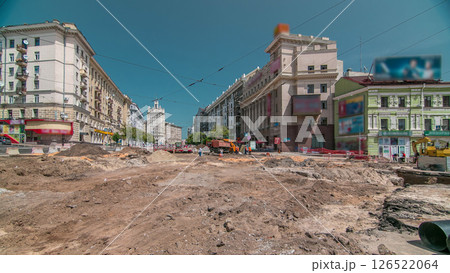Excavator working on earthmoving at open pit mining in the city street timelapse. 126522064
