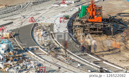 Concrete works for road construction with many workers and mixer timelapse Concrete works for road construction with many workers and mixer timelapse 126522082
