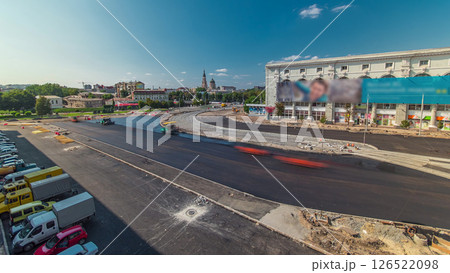 Workers operating asphalt paver machines during road construction and repairing works timelapse Workers operating asphalt paver machines during road construction and repairing works timelapse 126522098