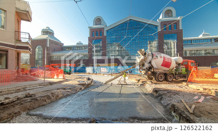 Concrete works for road maintenance construction site with many workers and mixer timelapse 126522162