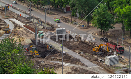 Industrial truck loader excavator moving earth and loading into a dumper truck timelapse 126522182