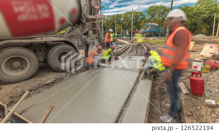 Concrete works for road construction with many workers and mixer timelapse hyperlapse Concrete works for road construction with many workers and mixer timelapse hyperlapse 126522194