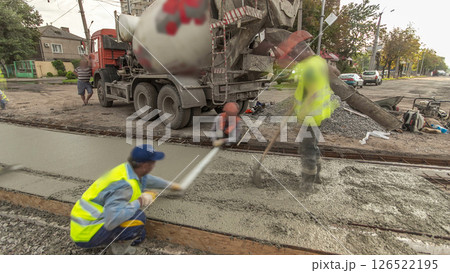 Concrete works for road construction with many workers and mixer timelapse hyperlapse 126522195