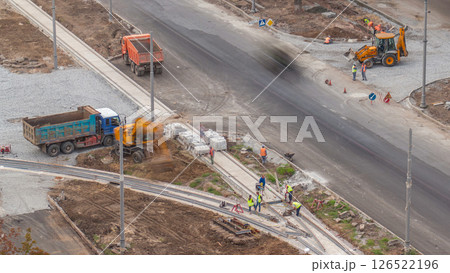 Industrial truck loader excavator moving ground and loading into a dumper truck timelapse 126522196