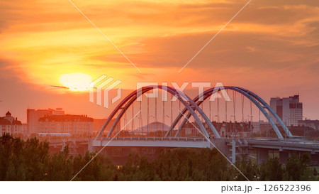 Sunset timelapse above the Bridge with the transport and clouds on the background. Central Asia, Kazakhstan, Astana 126522396