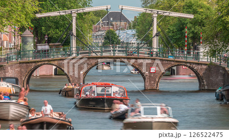 Timelapse of a busy canal boat trip in Amsterdam's city center on a sunny day. Amsterdam, Netherlands Timelapse of a busy canal boat trip in Amsterdam's city center on a sunny day. Amsterdam, Netherlands 126522475