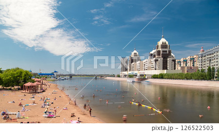 People are bathing in a river along an artificial beach timelapse hyperlapse and skyline of Astana, Kazakhstan 126522503
