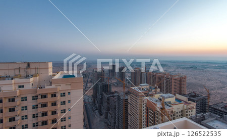 Cityscape of Ajman from rooftop before sunrise night to day timelapse. United Arab Emirates. 126522535