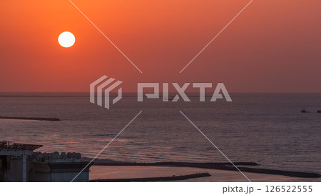 Sunset in Ajman aerial view from rooftop timelapse. United Arab Emirates. 126522555
