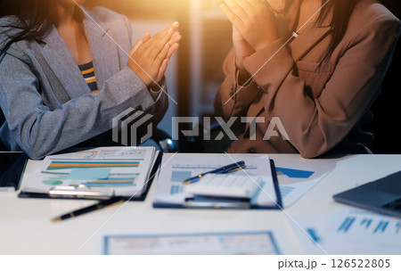 A successful business meeting with teamwork and collaboration, featuring a diverse group of professionals, including a young Asian businesswoman, in a modern office setting. A successful business meeting with teamwork and collaboration, featuring a diverse group of professionals, including a young Asian businesswoman, in a modern office setting. 126522805