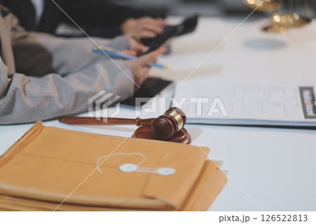 Judge gavel with Justice lawyers having team meeting at law firm background. Concepts of Law and Legal services. Judge gavel with Justice lawyers having team meeting at law firm background. Concepts of Law and Legal services. 126522813