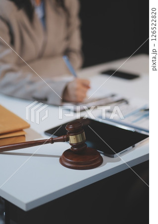 Judge gavel with Justice lawyers having team meeting at law firm background. Concepts of Law and Legal services. 126522820